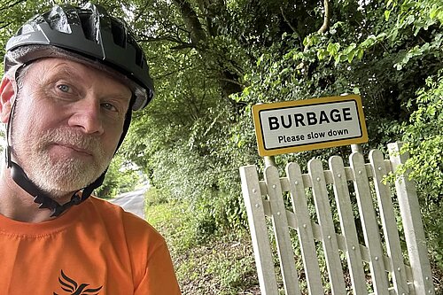 David Kinnaird with Burbage sign on his bike tour