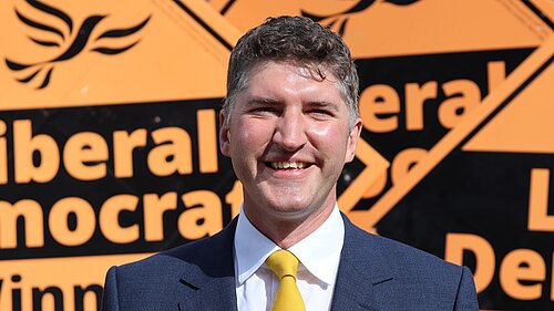 Edward Morello Stood in front of Liberal Democrat Stake Boards