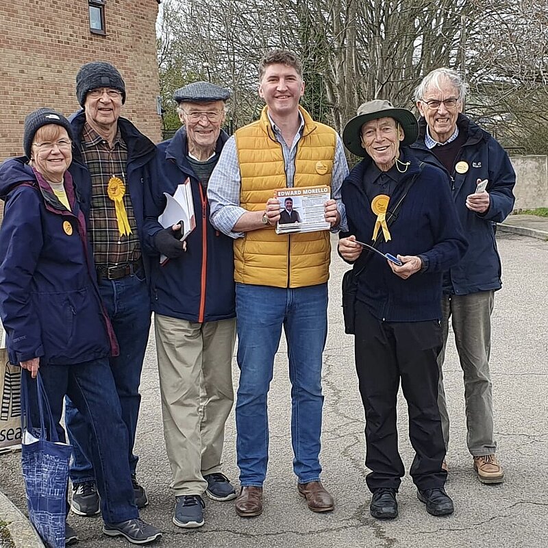 A Group of Lib Dem volunteers standing Smiling with Edward Morello