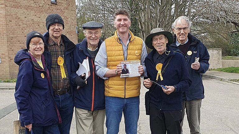 A Group of Lib Dem volunteers standing Smiling with Edward Morello