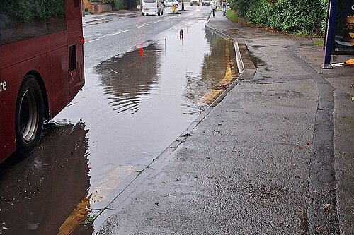 The windmill lane bus stop underwater after heavy rain