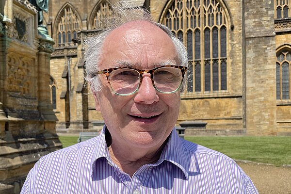 Richard Crabb stood in front of Sherborne Abbey