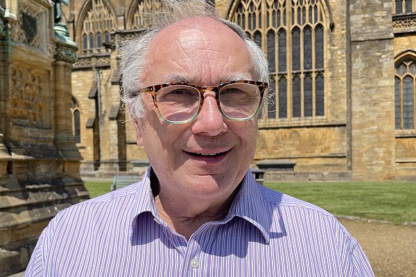 Richard Crabb stood in front of Sherborne Abbey