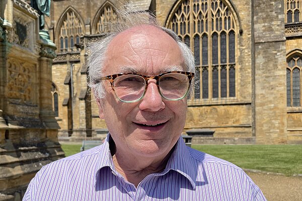 Richard Crabb stood in front of Sherborne Abbey