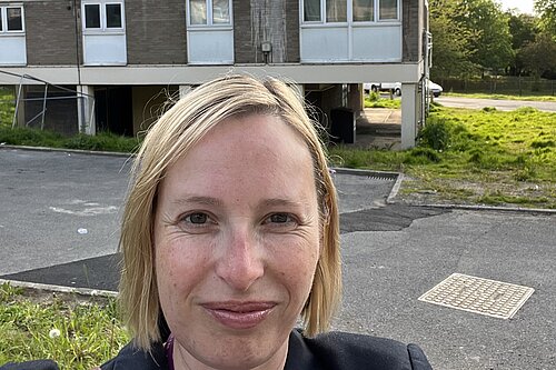 Claire standing outside Croydon council housing