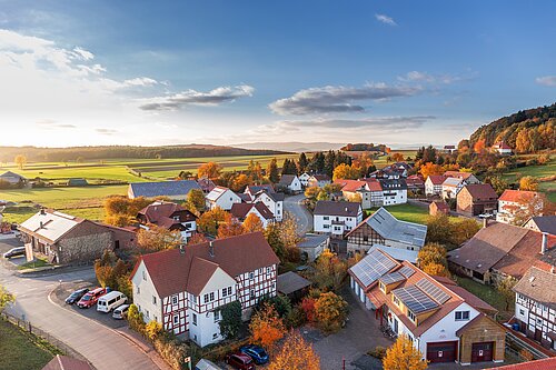 An aerial view of a village in the countryside.