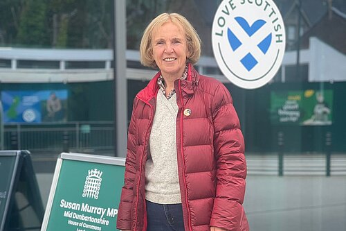 Susan Murray MP standing next to a A board reading the words Susan Murray MP Advice Surgery.