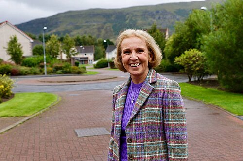 Susan in check jacket with hill in background