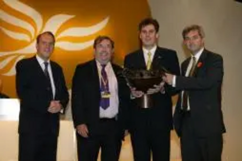 Party President Simon Hughes MP presents the award to David Chidgey MP, local party Chairman Cllr David Goodall & Chris Huhne MEP.