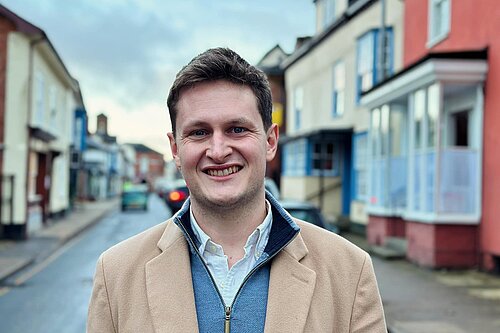 Headshot of David Chadwick standing on a local high street