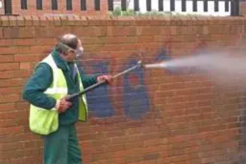 StreetCare Chargehand Jeff Smith blasts graffiti from a wall in West End