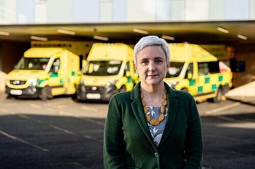 Alex in front of a local hospital's ambulance bay.