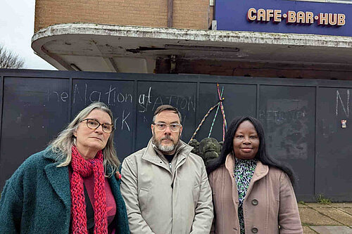 Councillors Edwina Livesey, Kevin West and Janet Baah outside the boarded up and delapidated remains of the bus station