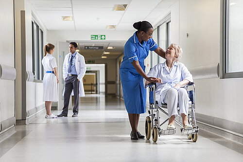 A nurse helping a patient in a wheelchair