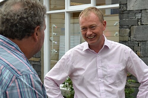 Tim Farron listening to a local resident