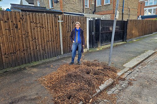 Liberal Democrat Campaigner Naomi McCarthy sanding on the site of a felled street tree