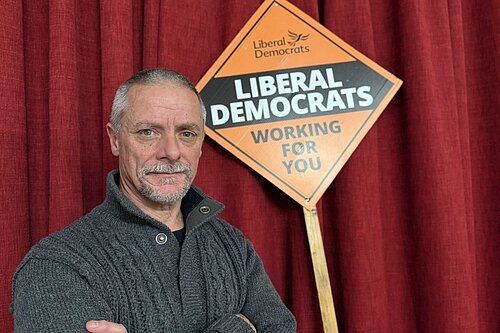 Greg stood in front of Lib Dem Stake Board