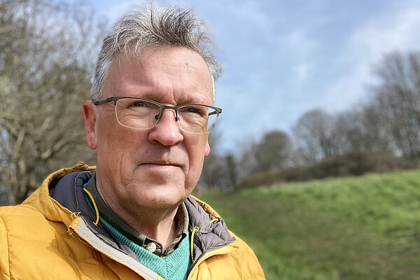 Paddy Mooney wearing a yellow jacket in a field