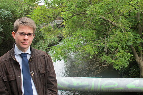 A man standing next to a river