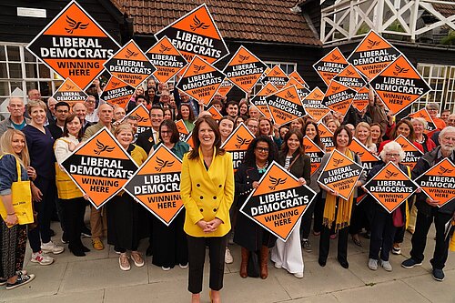 Monica surrounded by supporters with diamond boards