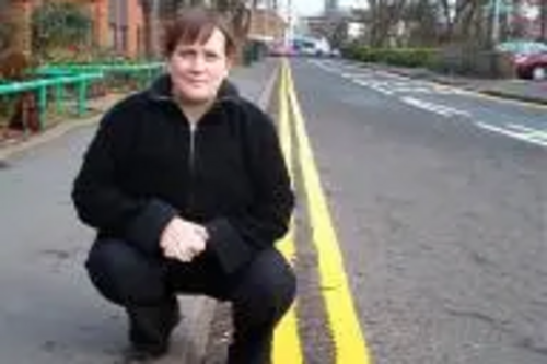 Debbie Almey next to the newly painted double yellow lines on Jarrom Street.