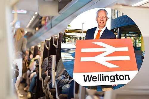 Gideon Amos with Wellington train station sign