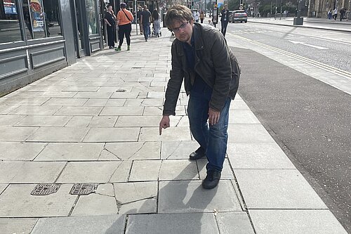 Jack Caldwell pointing at pavements