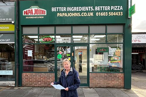 Cllr Lubbock in front of Pappa Johns delivery shop on Colman Road.