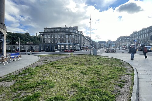 The corner of London Road and Elm Row on a lightly clouded day